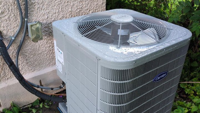 An AC unit outside a pink house in Minneapolis.