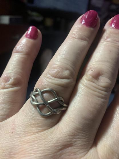 Kit’s hand has burgundy nails and a freshly made elven-style Mithril ring.   (Actually copper from a transformer and nickel plating grown from battery strips)