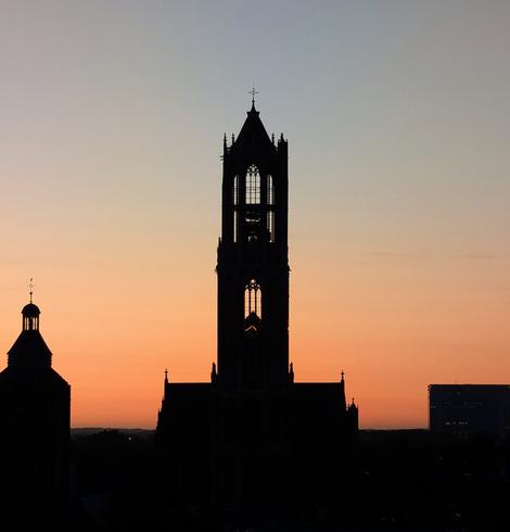 Dom Tower against red-blue morning twilight.