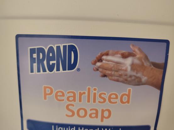 a lable for a commercial sized bittole of 'frand' pearlised soap' white, blue, with a hint of orange, the vive is excell spreedsheet meets  'gtaphic design is NOT my passon' a pair of hands is washing themselves as though called from beyond, help im trapped in an image description