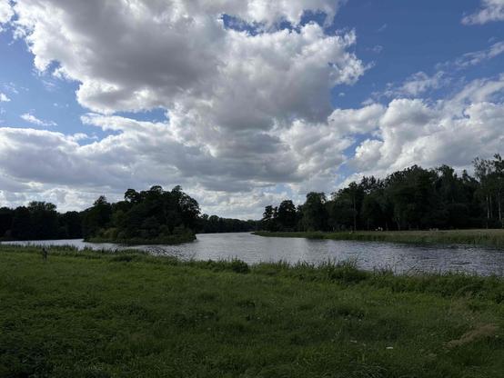Photo of a lake. Water trees and blue sky.