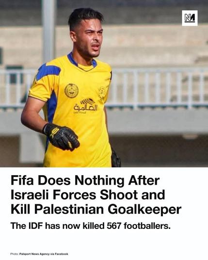 A news graphic featuring a photograph of an individual in sports attire accompanied by large text. The person wears a yellow and blue jersey and black goalkeeper gloves, with short dark hair and an intense facial expression against a blurred background. In the top right corner, there is a small white square icon containing a black letter 'N'. Large bold text reads, "Fifa Does Nothing After Israeli Forces Shoot and Kill Palestinian Goalkeeper," followed by the sub-headline, "The IDF has now killed 567 footballers." At the bottom left, smaller text states, "Photo: Palsport News Agency via Facebook."