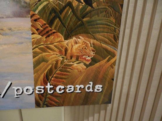 A close-up of the banner, showing the extreme right side. This part includes a detail from the Henri Rousseau painting Surprise, with a tiger getting ready to pounce in a rainforest.