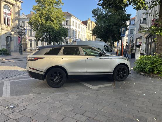 A SUV front wheels on the pavement