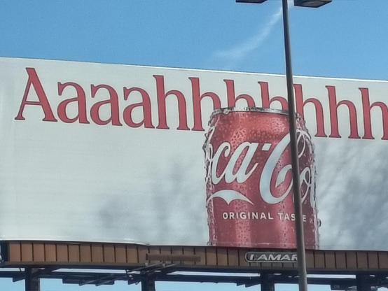 Cocal cola advertisement. A coke can on white background. Red ext in background goes Aaaahhhhhhhhhhhhh as if screaming while being murdered