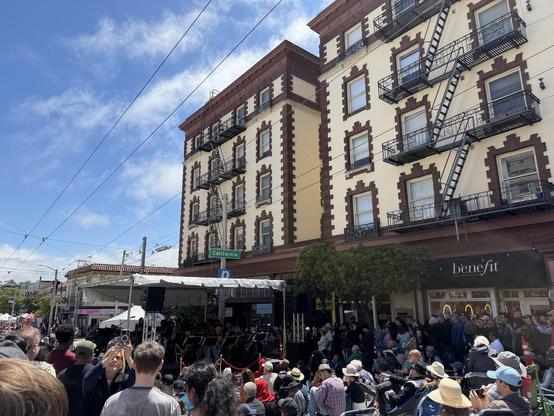 Orchestra performing on stage in the street