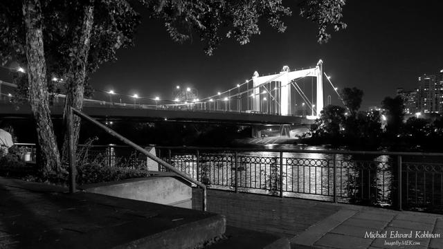 Title: Father Hennepin Bridge

The Father Louis Hennepin Bridge, taken around Midnight on July 4th, 2013, along a quiet walkway on the western side of the Mississippi River.

Image is n Black and White