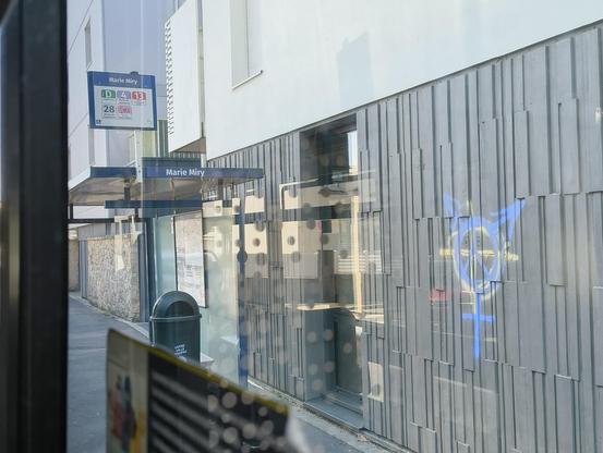 Mairie Miry bus stop. A fascist symbol has been overwritten by a transgender sign