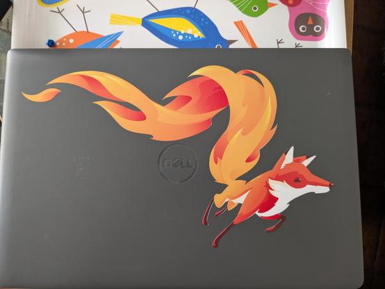 Photo of a laptop cover with a sticker of a running fox on it. The fox was the mascot of the late firefoxOS