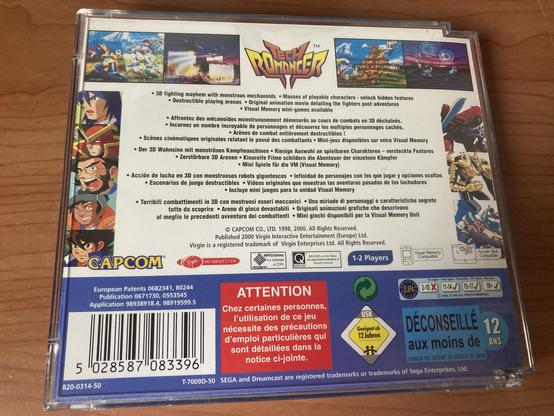 The image shows the back cover of the video game "Tech Romancer" by Capcom. It features a colorful design with multiple images of characters and gameplay scenes. The text describes game features such as 3D fighting mechanics, character customization.