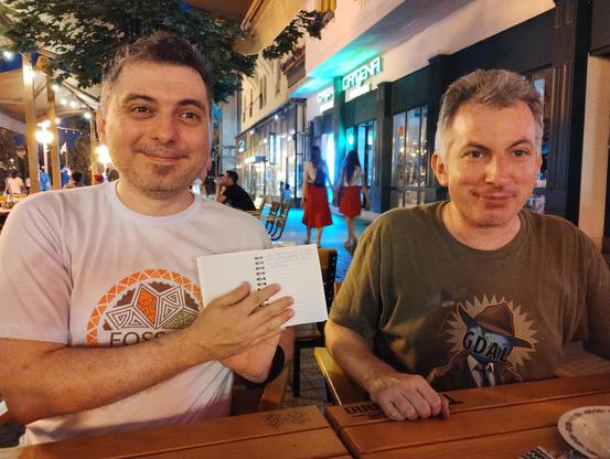 Iván holding a notebook next to Even.