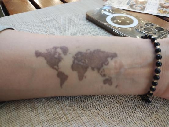 Map of the world tattooed on the arm