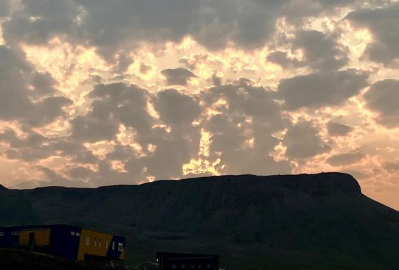 A cropped version of the earlier posted photo. The way the clouds are parted in the centre of the photo makes it appear as though there is a giant fiery yellow hand giving someone the finger.