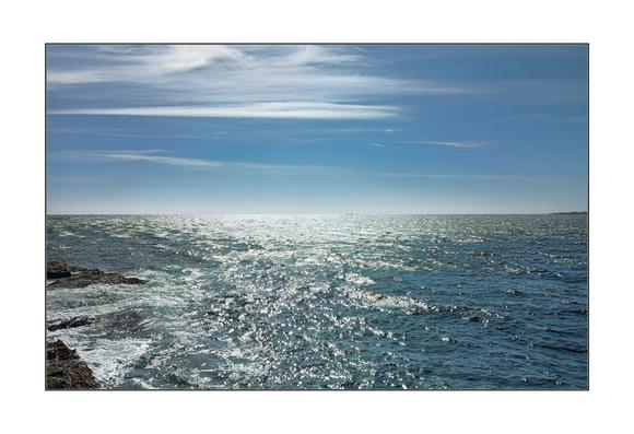 A colour photo of the ocean under the blue sky.