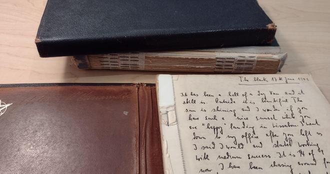 One closed and one open volume, inside slipcases.
