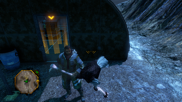 A man with a long overcoat and a headset standing in a stony canyon near a building. He is holding an ostrich by the neck, its legs bound. A small map with a green indicator is in the bottom left of the screen.