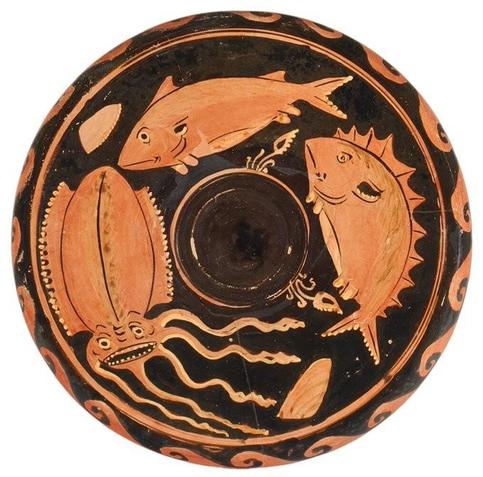 This circular red-figured fish plate features three marine creatures depicted in red against a black glazed background: a squid and two fish.