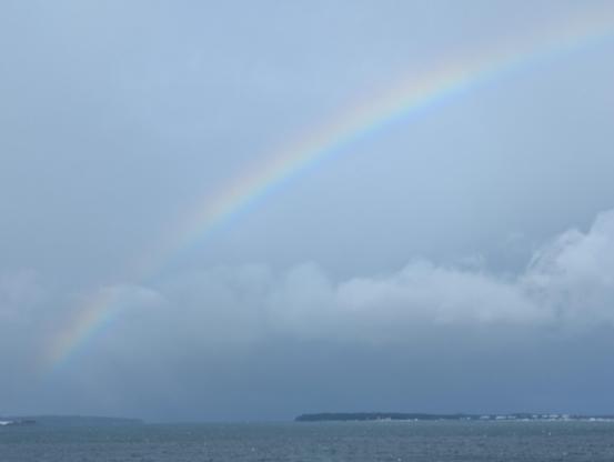 A rainbow spanning across botany bay headlands