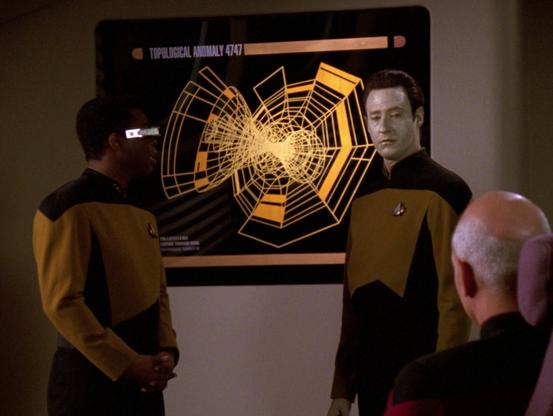 Screencap of Star Trek TNG episode "I, Borg" S5E23. Geordi and Data are giving a briefing to Picard about Topological Anomaly 4747, displayed on the screen on the wall. It's a spiderweb, if spiderwebs could be spun entirely throughout a 3-dimensional Klein bottle.

The plan is to show the anomaly shape to a captive Borg and then send it back to the collective to spread it and eventually soft lock the entire species.