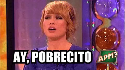 a woman with blond-red hair in a ponytail with what looks like the backdrop of a game show says "Ay, pobrecito" which is Spanish for "Oh, poor little one!"