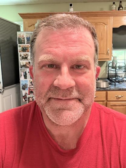 Yours truly in a kitchen. I’m wearing a red (and soaking wet) t-shirt and looking directly at the camera. My face is really red, but whether it’s the heat, the reflection from the shirt, or sunburn is up to the viewer. Also, I look tired yet somehow still powerfully sexy.