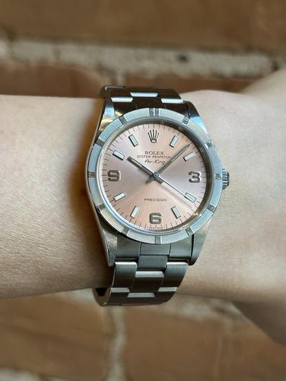 Wrist shot of a Rolex 14010 with sun light at dawn.