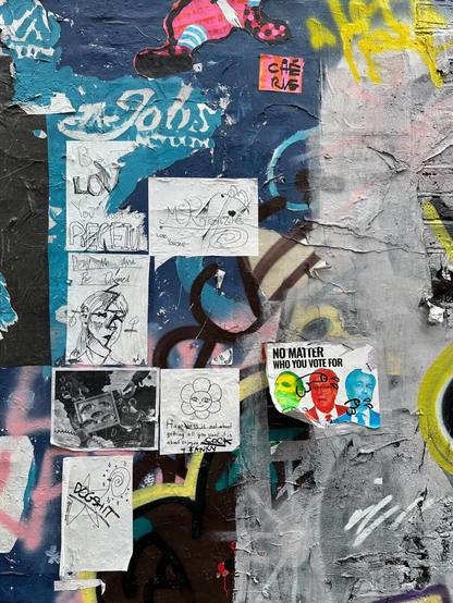 a wall covered with layers of graffiti, and a more recent spate of pasted-up A4 sheets, most of them in black and white, with drawings and phrases written on them. Some have subsequently been modified with commentary, consisting mostly of swear words and crude drawings of ejaculating penises, in black felt tip marker