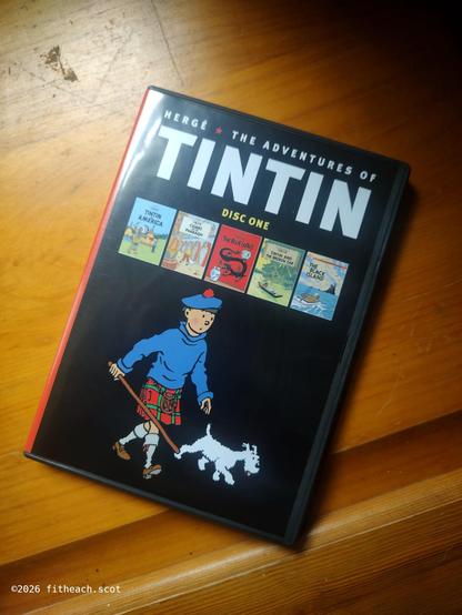 The "Adventures of Tintin" DVD case, showing Tintin and Snowy (Milou), Tintin is dressed in a kilt.