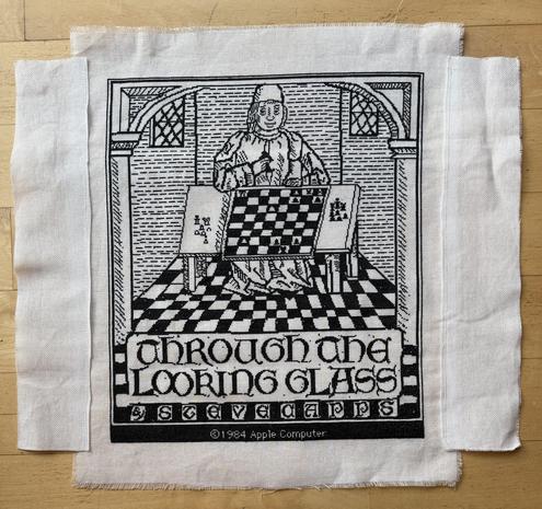 Cross-stitch of black stitches on white background, man in robes playing chess with a checkerboard floor and columns to the sides. The words “Through the Looking Glass” and “by Steve Capps” at the bottom.