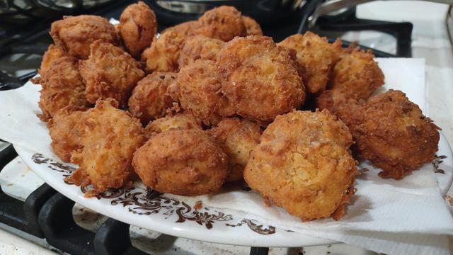 A platter of golden brown and delicious deep fried sourdough cornbread battered sausage bites.