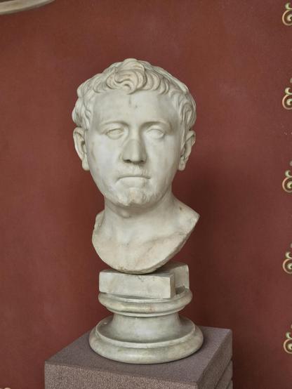 A Roman marble portrait of a man in a museum setting