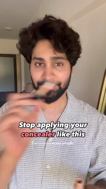 A person with wavy dark hair, a trim beard, and moderately dark skin shows how to apply foundation to the bags under your eyes. Subtitle "stop applying your concealer like this."

Transcript:
I've seen so many people use a lighter concealer under their eyes like this to brighten up this area, and I'm sorry to say but this looks horrible. Especially if you have proper dark circles and also your under eyes are hollow like mine. Like I literally have contours under my eyes. And nobody talks about this, everybody's just blindly following trends. Instead of, you know, doing makeup as per your own face structure.

So first, colour correct your under eyes. Colour correction is extremely important, otherwise no matter how expensive you concealer is, your under eyes will always look ashy. Now when you apply lighter concealer on hollow under eyes it highlights them more and the point is you don't want people to notice the hollowness. So you use a shade that matches your skin, see how that completely blends into your skin.

And now you take the lighter concealer and instead of brightening the under eye we're going to create a bright spot on the cheek, right in the centre of the eye and on the cheek bone. Now join them by blending them together.

And now the focus will shift from the hollowness of the under eye to the cheek bones and your face will look more lifted. And once you set your under eyes with powder you can't even notice your under eyes so much. The idea is to draw attention away from your hollow under eyes, instead of highlighting them. Save this video and follow me for more.