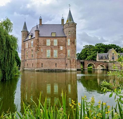 Op deze foto een kasteel, met water eromheen, en veel groen, en mooie wolken. Fijn weekend!