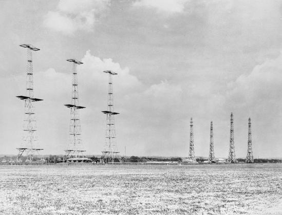 “Going against the prevailing thought, the British devised one of the world’s first integrated air defense systems. Key to this integrated defense was the “Chain-Home” radar network built in 1939 that included some 21 towers ringing the British coastline. This rudimentary system was able to “sight” an incoming aircraft at ranges up to 200 miles but was more effective at only 80. Regardless, finding inbound formations at the lower range still provided plenty of time to scramble a squadron to meet an incoming raid. 

While Chain-Home radar was able to detect aircraft at higher altitudes, it could not detect those coming in at less than 1,000 feet. To cover this gap, the RAF also built “Chain-Home-Low” radars that scanned lower altitudes but only up to 30 miles. Interestingly, the Germans were aware of the RAF radar system but had no real understanding of its capabilities or coverage and failed to knock it out.”

“Chain Home radar installation at Poling, Sussex, 1945.
Chain Home: AMES Type 1 CH East Coast radar installation at Poling, Sussex. On the left are three (originally four) in-line 360ft steel transmitter towers, between which the transmitter aerials were slung, with the heavily protected transmitter building in front. On the right are four 240ft wooden receiver towers placed in rhombic formation, with the receiver building in the middle.”

credit https://en.wikipedia.org/wiki/File:Chain_Home_radar_installation_at_Poling,_Sussex,_1945._CH15173.jpg

source https://www.nationalww2museum.org/war/articles/battle-britain-not-so-few