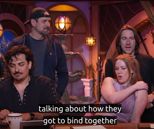 Four cast members of critical role. Caption text: "...talking about how they got to bind together..."