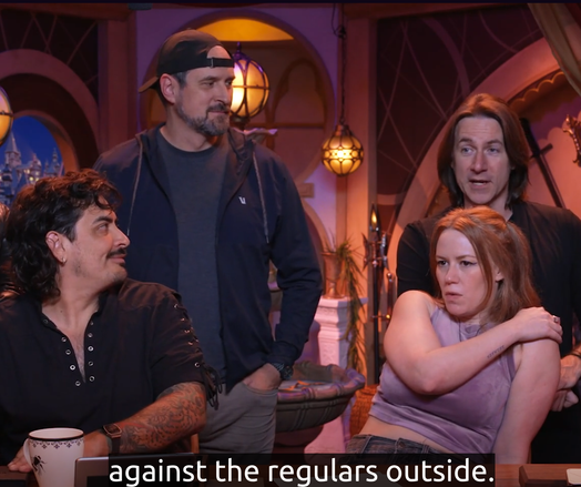 Four cast members of critical role. Caption text: "...against the regulars outside..."