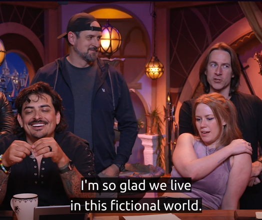 Four cast members of critical role. Caption text: "...I'm so glad we live in this fictional world." Also at this point Matt is giving a side eye.