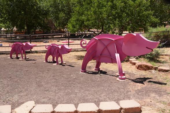 Metal sculpture of a sow with piglets