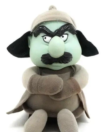 plush of Murky Dismal, bad guy from Rainbow Brite, short heavyset blue-faced man with grayscale clothes, arms crossed like he's sulking