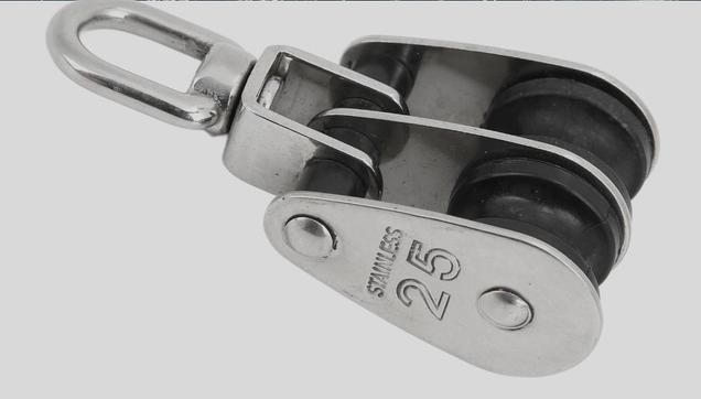 A marine block that shows how two pulleys can sit in the same housing. This is used to improve leverage on heavy loads.