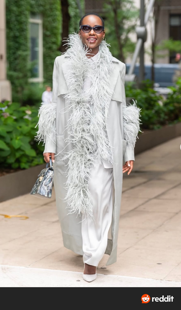 Lupita Nyongo, not sure of the designer. Wide leg white pants, silver duster with matching Marabou trim