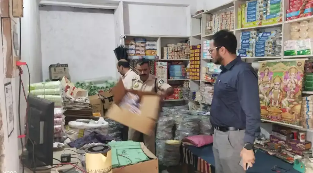 Pollution Board team seizing single use plastic from a shop in Baijnath.