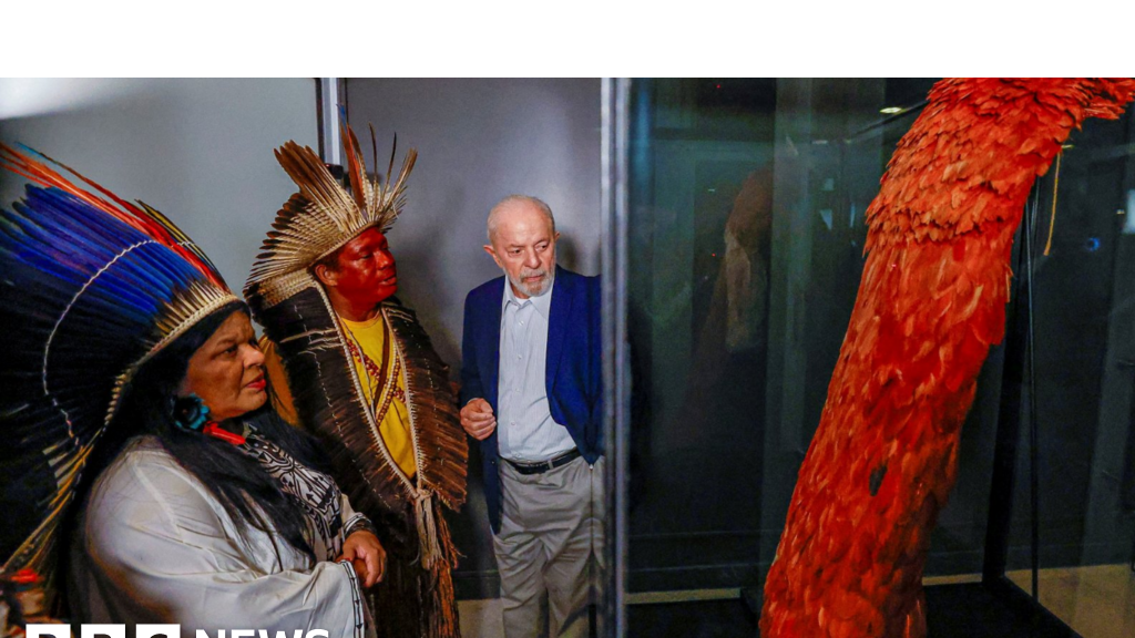 Brazil's President Luiz Lula da Silva accompanied by Sonia Guajajara, the Minister of Indigenous People, looks on at the Tupinamba cloak in Rio de Janiero