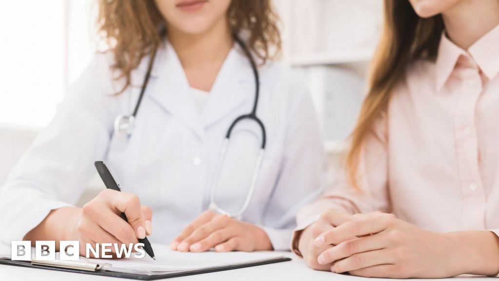 Doctor writing notes on a young patient