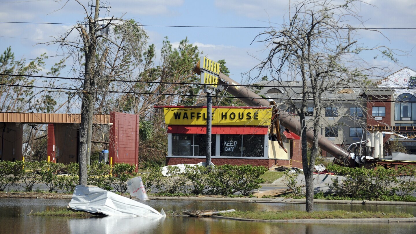 FILE - A billboard lies atop a Waffle House restaurant after being knocked down by Hurricane Michael in Panama City, Fla., Oct. 14, 2018. (Carlos R. Munoz/Sarasota Herald-Tribune via AP, File)