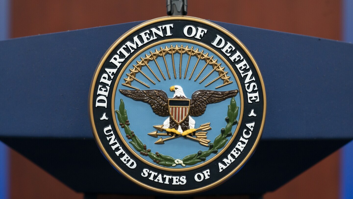 FILE - The seal of the Department of Defense is seen on the podium at the Pentagon, Sept. 27, 2022, in Washington. The Pentagon says the U.S. is sending an additional “few thousand” troops to the Middle East to bolster security and to be prepared to defend Israel if necessary. (AP Photo/Alex Brandon, File)