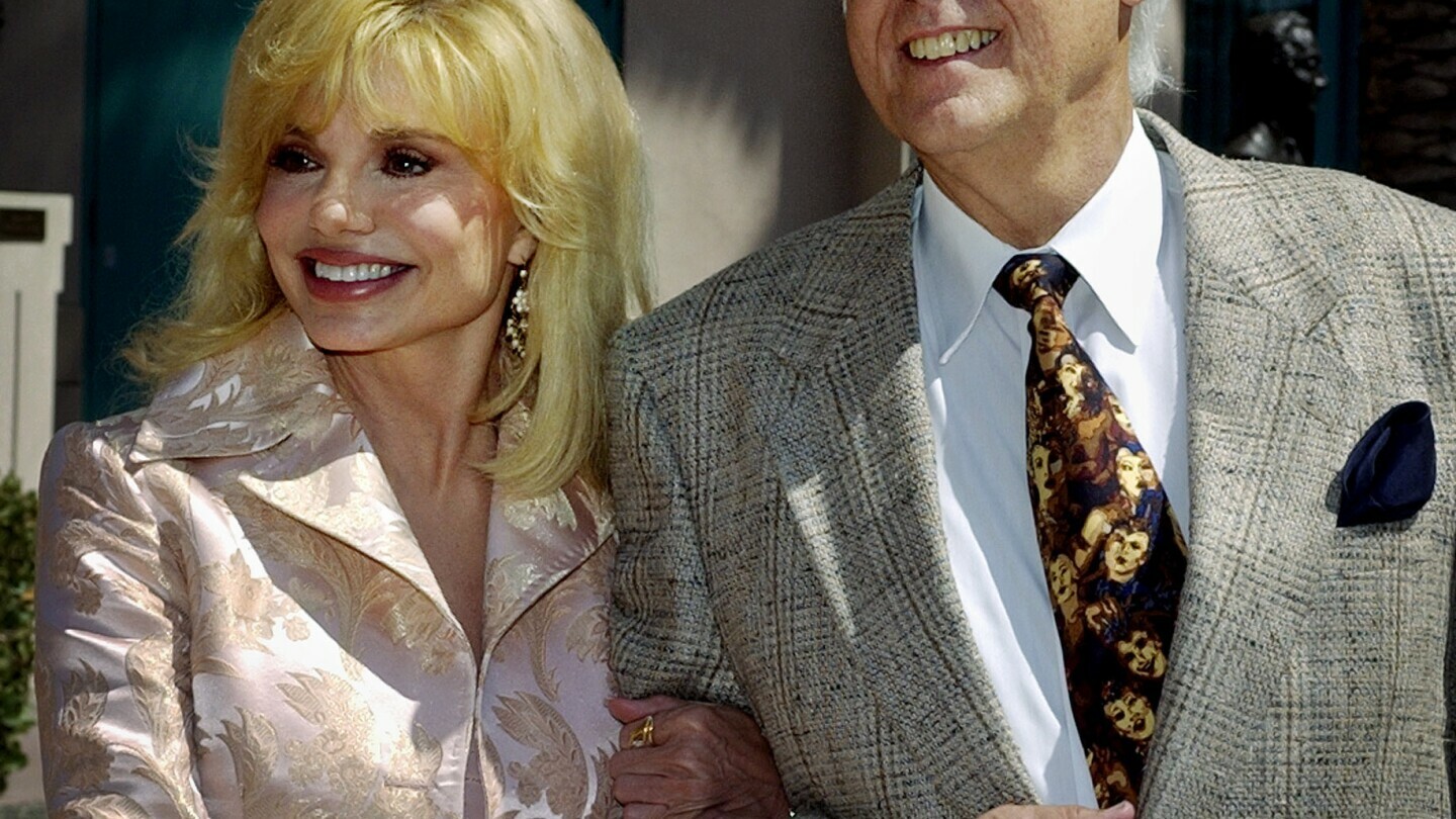 FILE - Loni Anderson and Jack Jones arrive for "The Bob Hope Memorial Tribute" show at the Academy of Television Arts and Sciences headquarters in Los Angeles' North Hollywood area Wednesday, Aug. 27, 2003. Jack Jones, a Grammy-winning crooner known for “The Love Boat” television show theme song, has died, Wednesday, Oct. 23, 2024. (AP Photo/Reed Saxon, File)