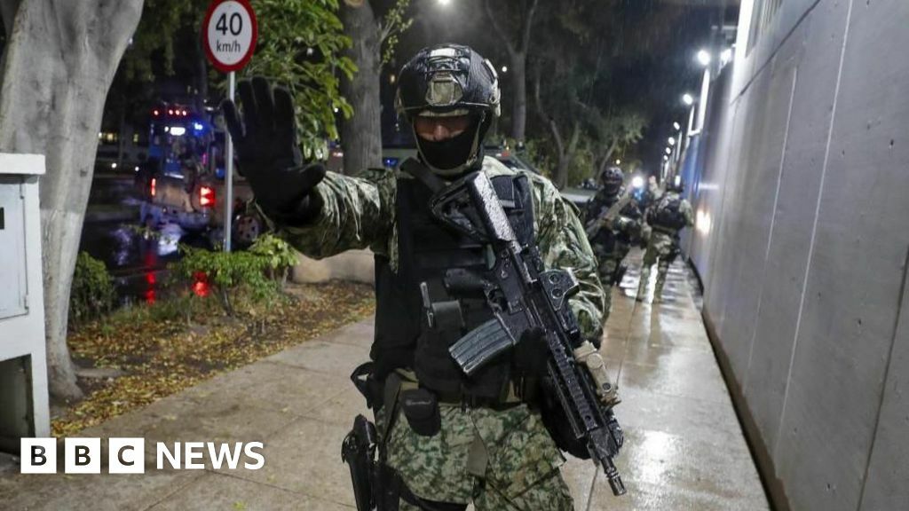 A Mexican soldier holds out his hand in a "stop" gesture as military forces guard the headquarters of the Specialised Prosecutor's Office for Organised Crime (Femdo) in Mexico City, Mexico, 22 November 2023