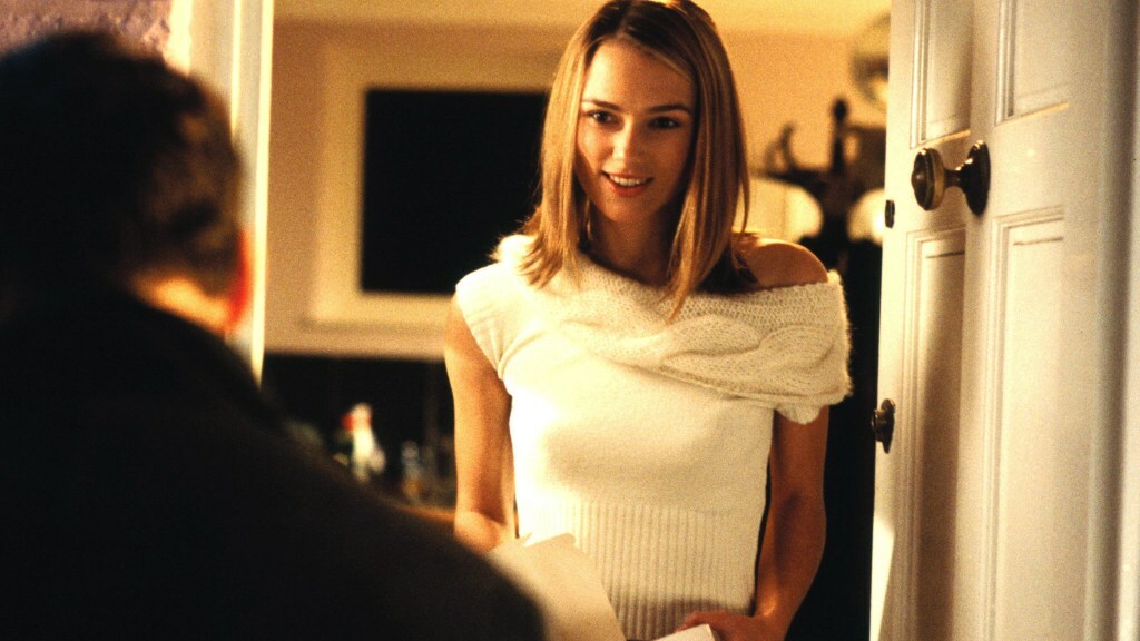 Keira Knightley stands in a doorway while looking at Andrew Lincoln, whose back is to the camera, in a still from 'Love Actually'.