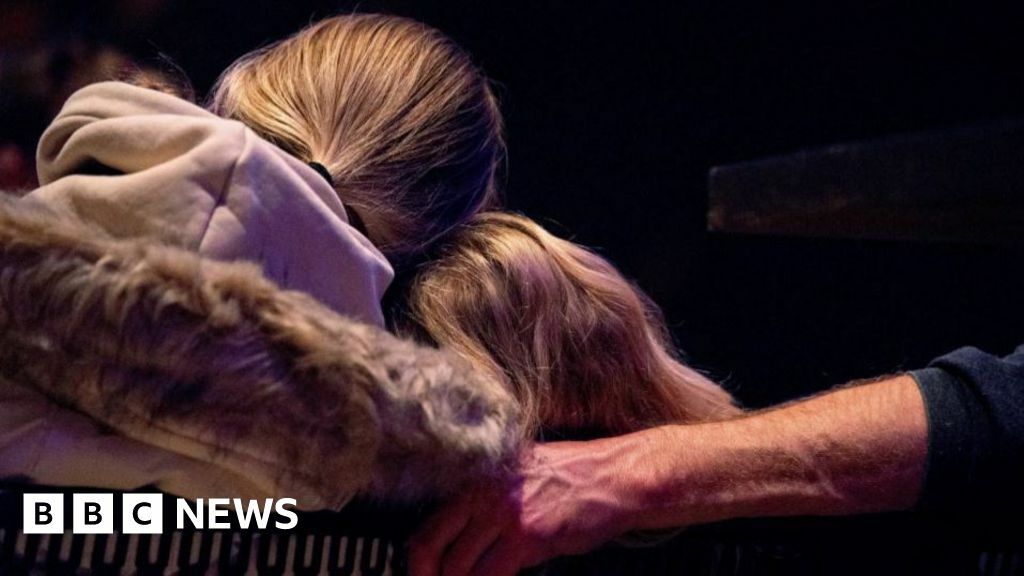 Two girls in church with backs turned